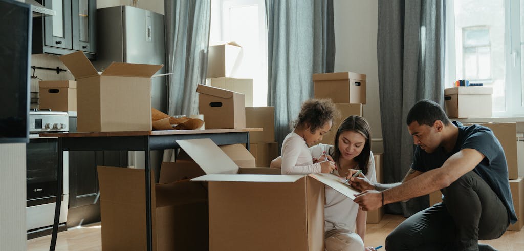 Family labeling a packed box.
