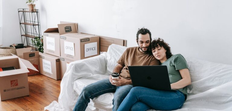 Couple on a computer while packing.