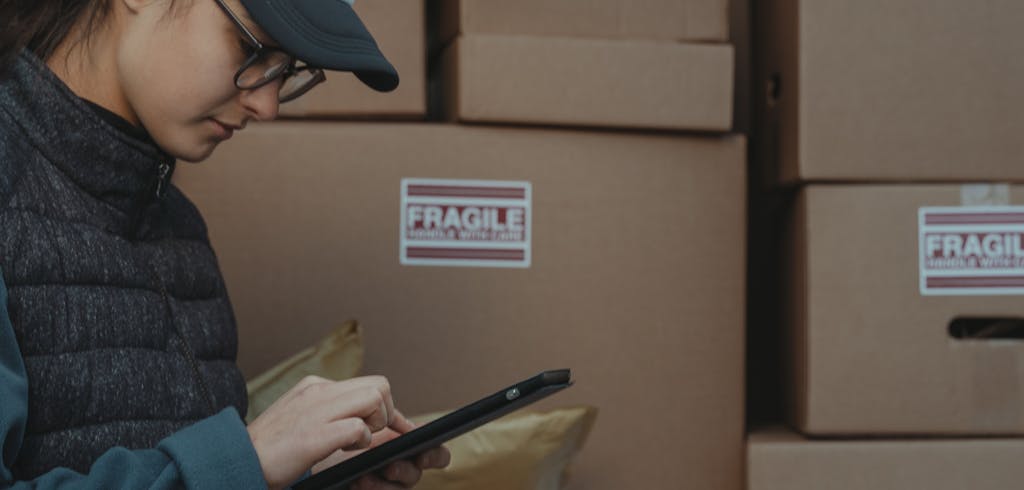 Women checking computer next to boxes